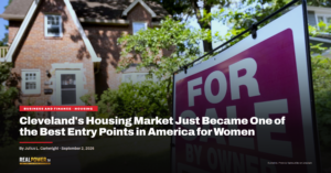A for-sale-by-owner sign outside a brick single-family home