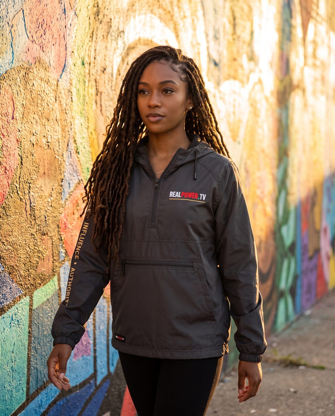 Model in The Authority Anorak in graphite by a mural