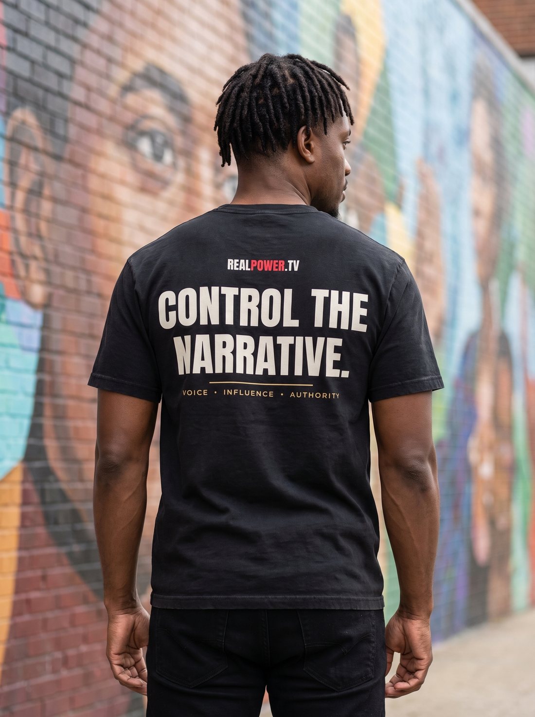 Model wearing the Control the Narrative tee, the message printed across the back