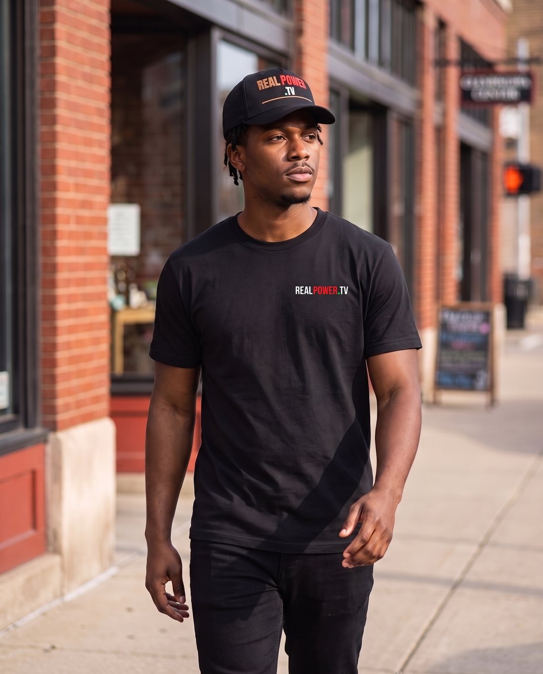 Model in the Control the Narrative tee with the embroidered cap