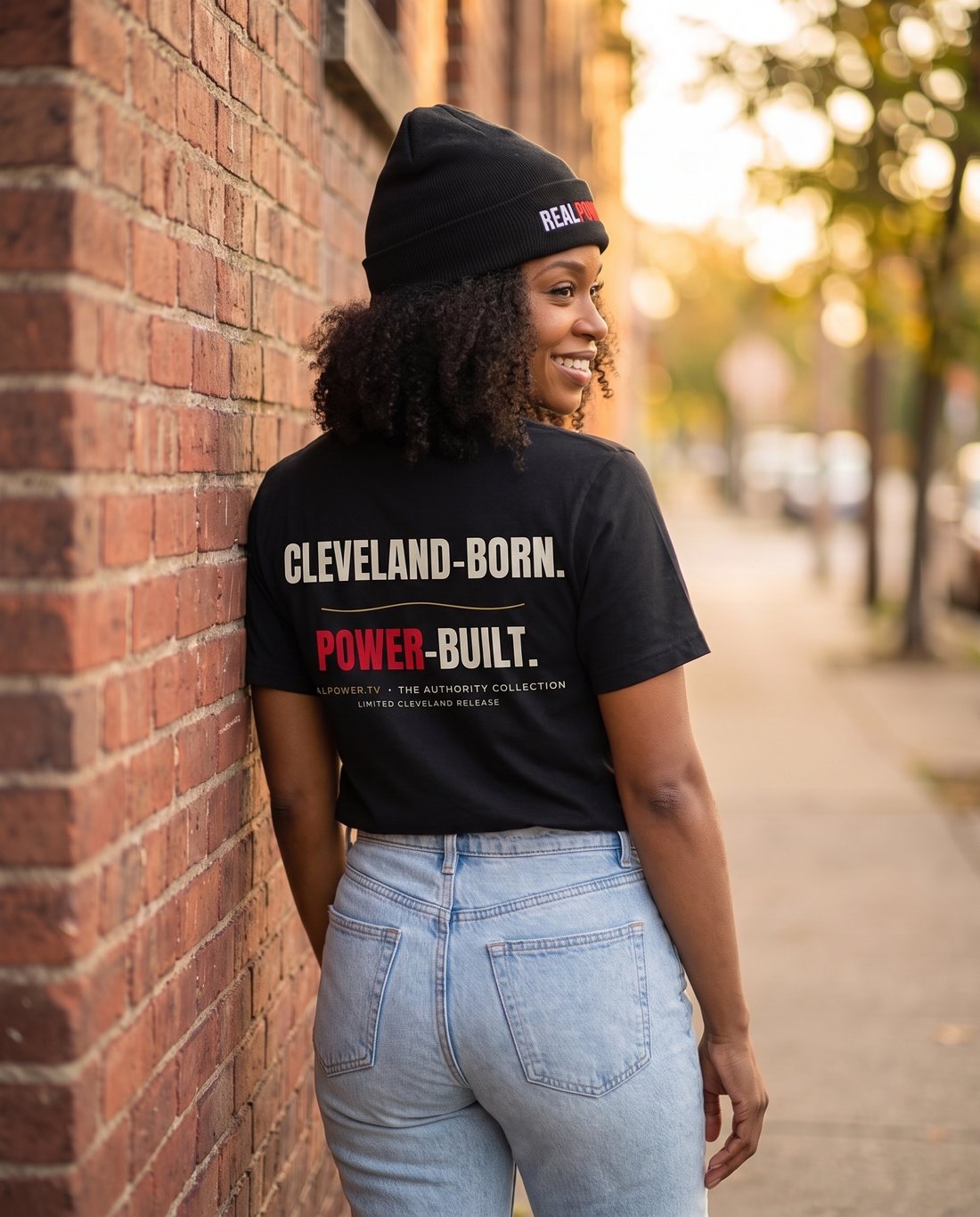 CLEVELAND-BORN. POWER-BUILT. across the back of her tee