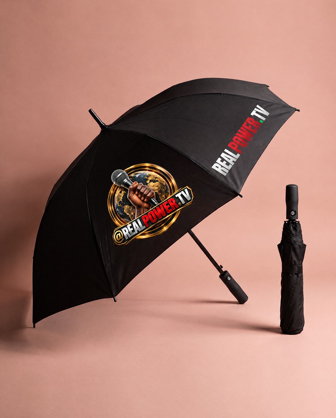 Black RealPower.TV umbrella with the fist-and-mic emblem and wordmark